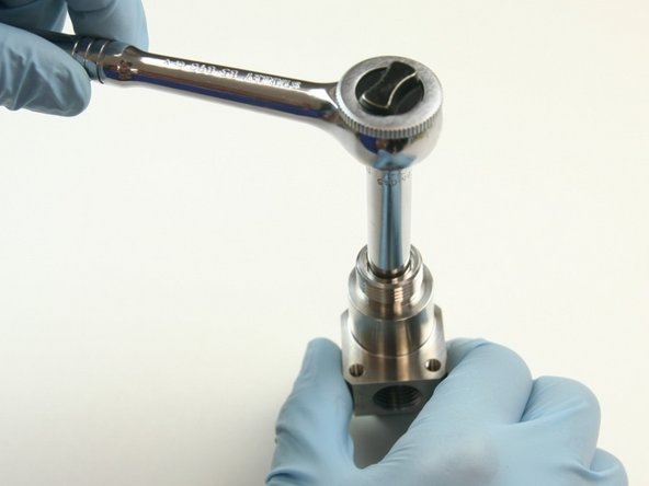 Loosen the back-up screw from the top of the bleed down valve body using  a 5/16&quot; socket wrench.