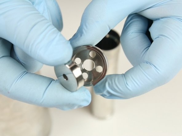 Put the low-pressure poppet into the low-pressure poppet basket with the stem of the poppet facing basket.