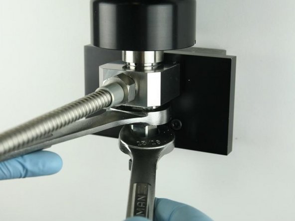 Tighten the adapter into the valve body using a 1" and 13/16" wrench.