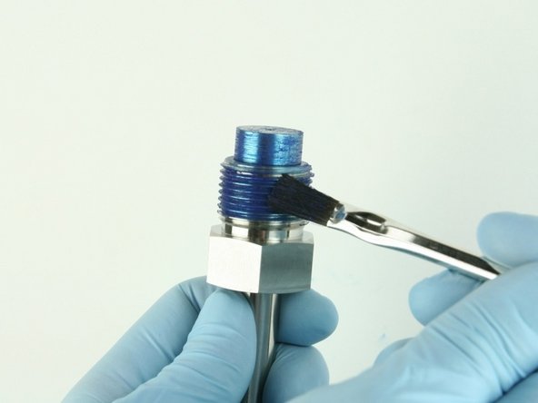Reapply Blue Goop to the threads of the high-pressure gland fitting and at the top of the nozzle tube.