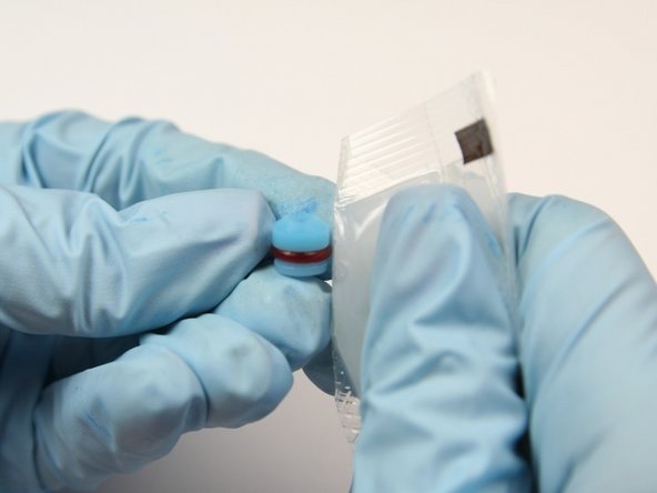 Apply a layer of high vacuum grease to the high-pressure seal from the kit.