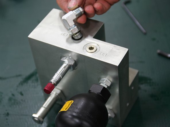 Install 90° fitting (6MJ-6MB90) into port stamped CP on top of new manifold.