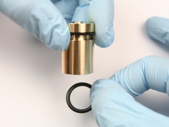 Slide the new O-ring (rounded) to the  groove of the piston.