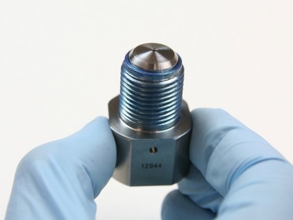 Place poppet seat into seat cavity of outlet adapter