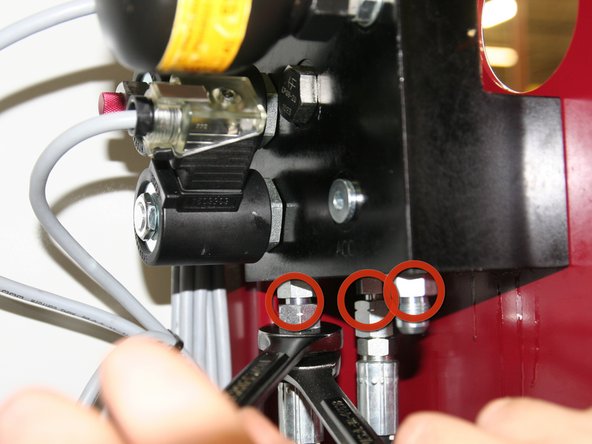 Disconnect hoses and fittings from bottom of old control manifold.