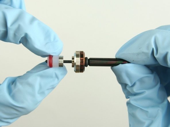 Slide the hoop and the high-pressure valve seal onto the valve stem with the hoop towards the brass back-up ring.