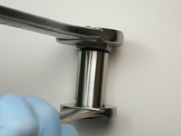 Tighten adapter fitting to actuator housing using 1-1/4&quot; and 1-1/16&quot; wrench
