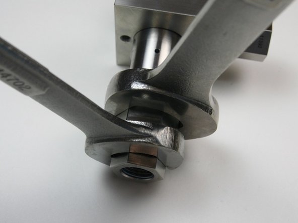 Tighten the 3/8" to 1/4" adapter to the  outlet adapter using a 7/8" and 13/16" wrench.