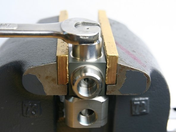 Using a 5/8&quot; wrench, loosen the thrust nut from the swivel housing.