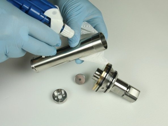 Clean the spacer tube, check valve,  low-pressure poppet, and low-pressure poppet basket.
