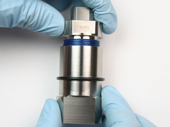 Thread bearing half of swivel housing into seal half of swivel housing.