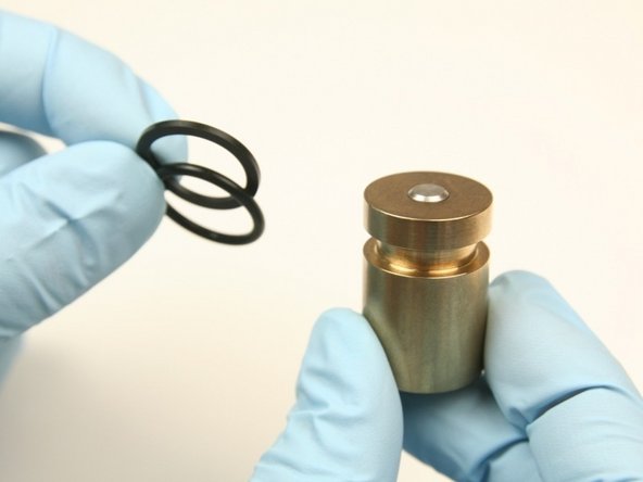 Discard the O-ring and the back-up ring from the piston.