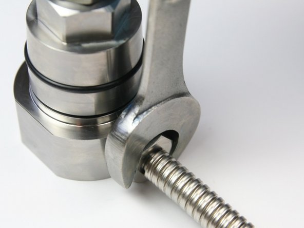 Tighten the high-pressure gland into the swivel housing with a 13/16" wrench.