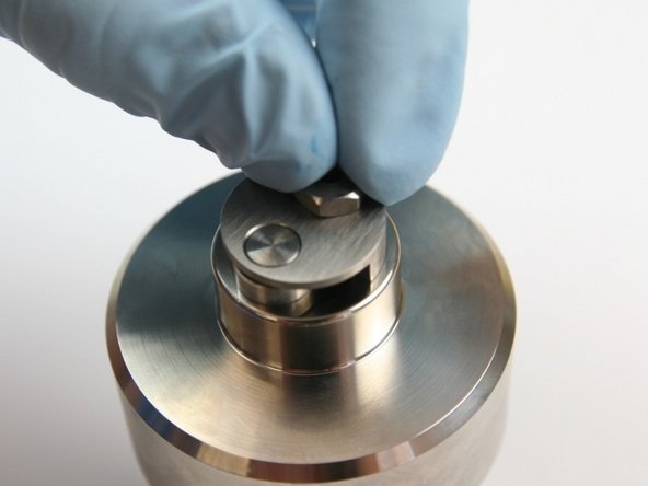 Thread in the retaining screw to the check valve body.