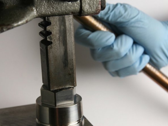 Using an arbor press, press the metal cased wiper into the cavity of the bearing half of the swivel housing (with the rubber-side down).