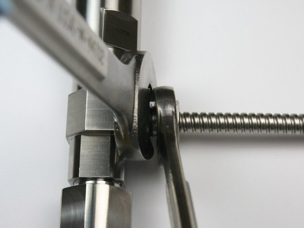 Tighten the gland nut to the side of the bleed down valve body using 3/4&quot; and 5/8&quot; wrench