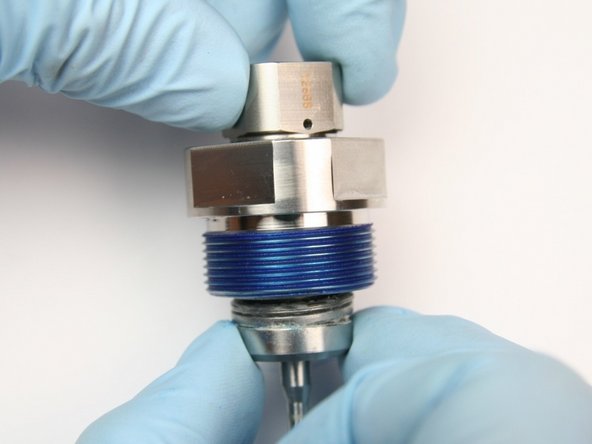 Unthread the swivel nut from the swivel shaft.