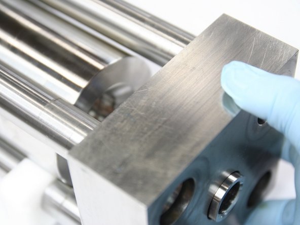 Slide HP endcap with check valve onto intensifier studs