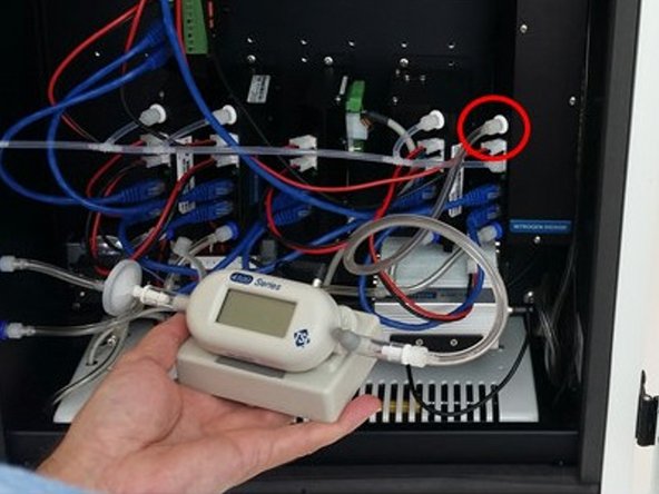 Disconnect the incoming PFA tubing from the the inlet port (white ring) of the gas module.