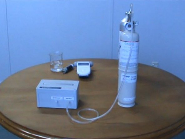 Push the tubing over the barb on the top of the gas regulator.