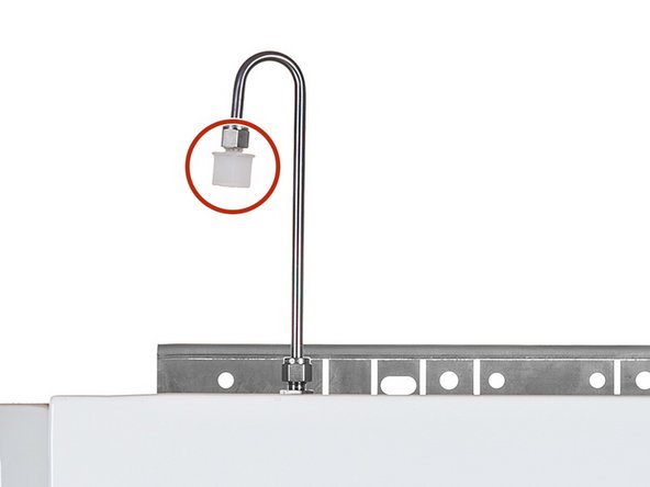 Remove the white inlet fitting containing the mesh filter.