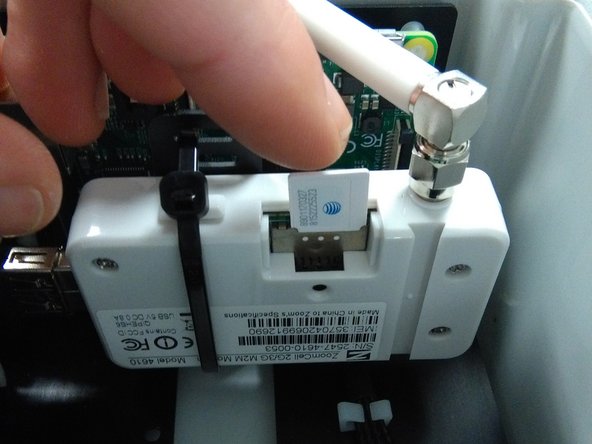 Push in the SIM with the connector face facing up and bevelled corner on the right.