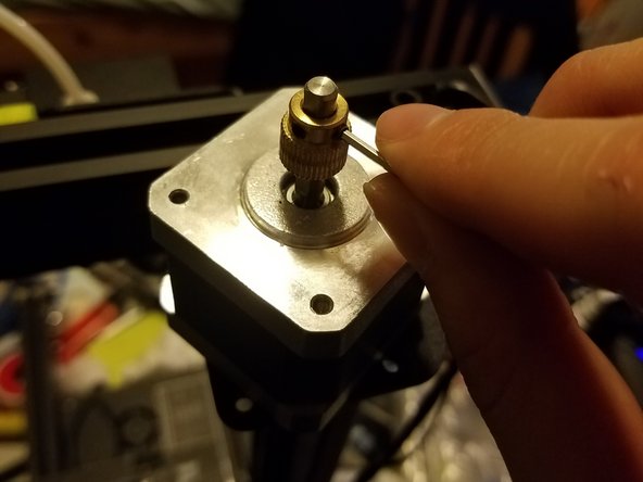 With the motor out, loosen the two grub screws holding the drive gear in place, and remove it.