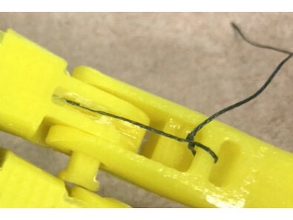 First, tie the string to the ring finger. The, slide it through the grooves until you get to the palm, then slide it through to the other side, then slide the string through the hand to the tensioner and pull it through back up the hand in the same way, and tie it off at the ring finger. (Repeat for middle finger and pointer finger)