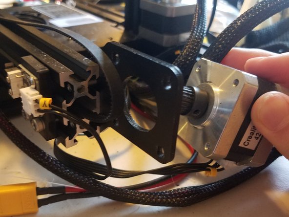 Gently tilt the motor housing backwards and out of its bracket, then disconnect its wire and put everything in a safe place