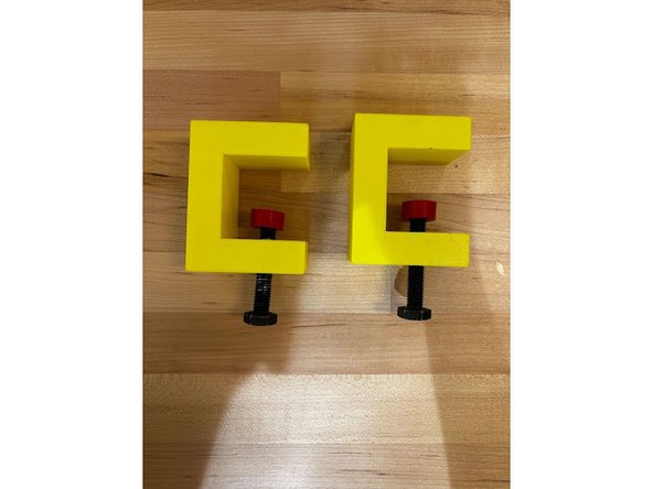 Screw in the bolt into the hole of the clamp.