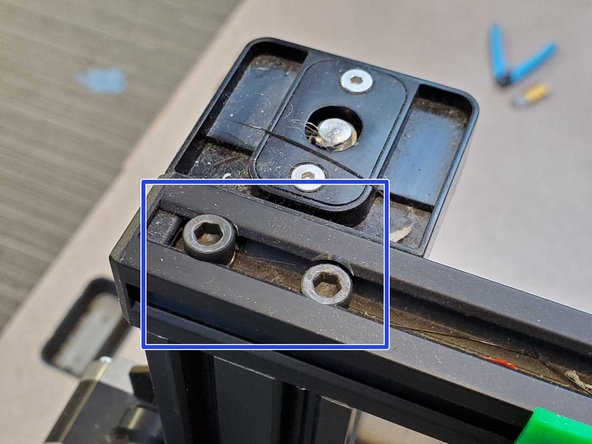 Undo the four large hex screws at the top of the frame and remove the top bar