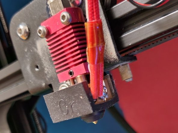 Reattach the pneumatic coupling and heat sock, making sure that the Bowden tube is pushed all the way into the block to sit snuggly against the nozzle.