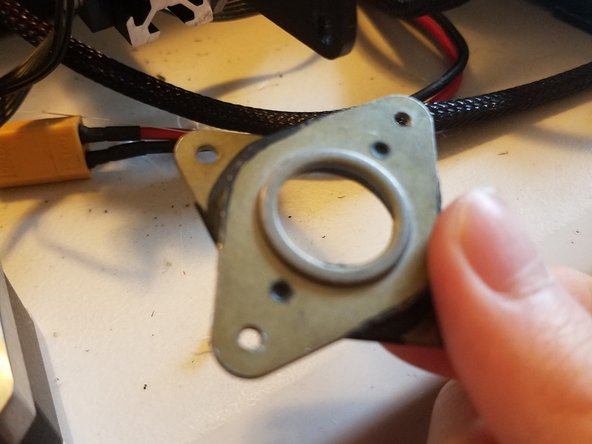 Fasten the two corners of the damper in contact with the motor with two of the screws originally used to hold the motor in place.