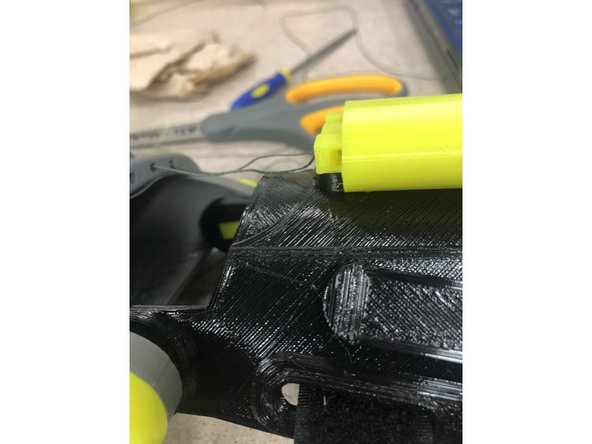 Once the tensioner is securely in, slide the tensioner pins in with the holes in the pins at the top, and the holes facing to the side.