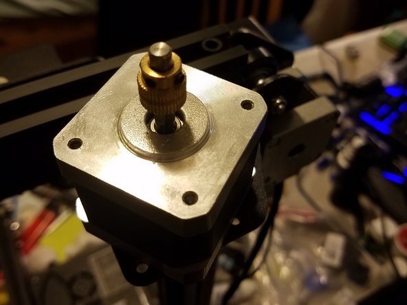 With the motor out, loosen the two grub screws holding the drive gear in place, and remove it.