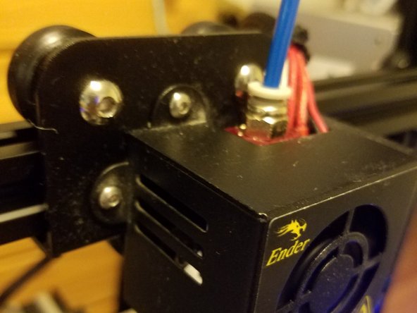 Fit the new bowden into the coupling while the hotend is still being heated.