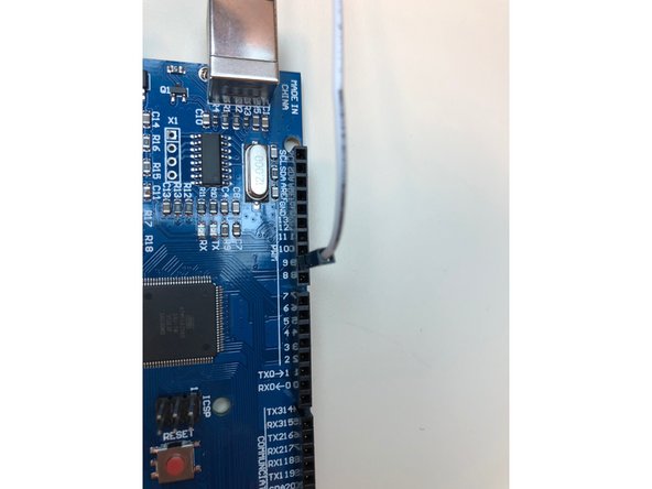 Attach a jumper wire(the thinner one with two pointed ends) from digital pin 9 to the orange colored female pin from the servo. Then, attach a male to male j. wire from the red wiring of the servo to the alligator clip from the positive end of the bench power supply and a male to male j. wire from the brown wire on the servo to the negative end.