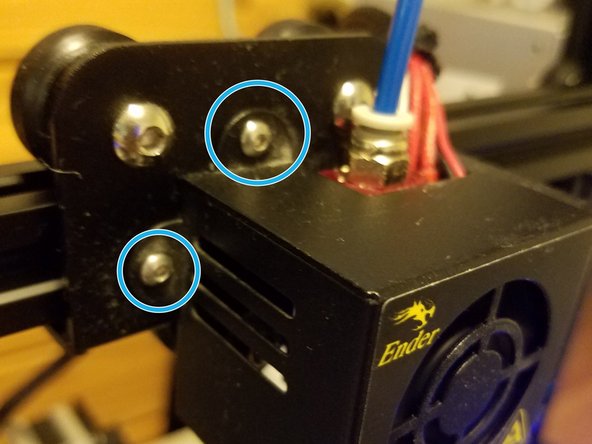 Keeping away from the extrusion column, swing the fan housing back into place, and re-affix the hex screws in place.