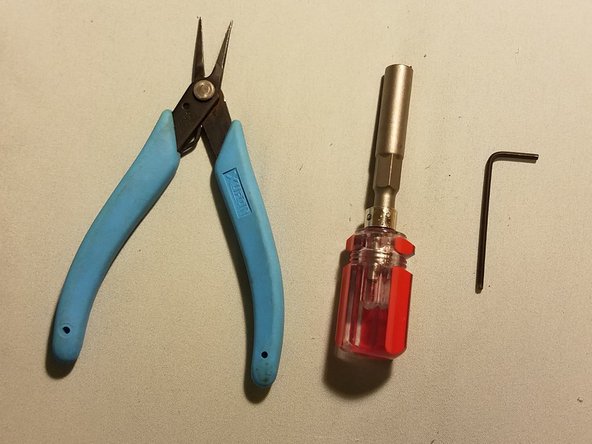 A screwdriver with a 6mm hex socket adapter, a pair of pliers, and one of your Allen keys
