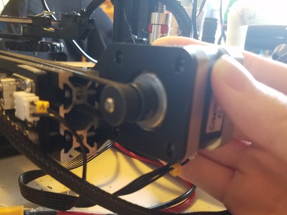 Undo the four hex bolts while using your hand to hold the motor in place.