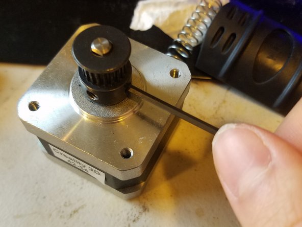 Pull it out of its bracket, this time disconnecting it from the printer so you can set it down on the table.