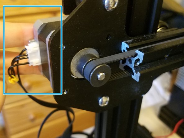 Remove the four screws holding the motor in, making sure to hold both it and the black cover in place while doing so.