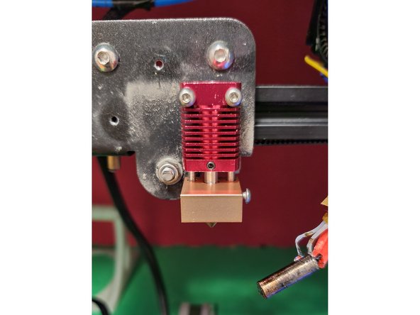 Remove the two screws holding the old block to the frame, and use them to attach the new one