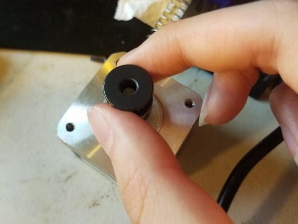 Loosen the grub screws on the gear just enough so that it travels up and down freely