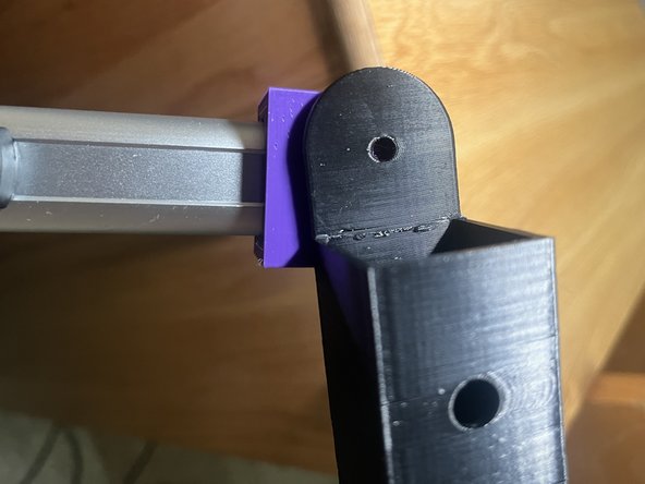 The hole in the top of the outer leg should then be aligned with the hole in the outer box, on the side away from the center of the wheelchair, so that the side of the outer leg with the hole faces inward.