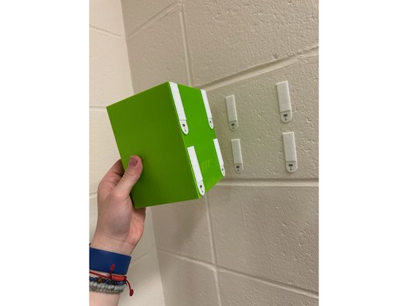 Hanging Installation: Attach 2 hooks into the slots on the bottom of the dispenser.