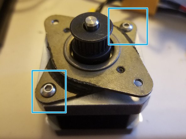 Fasten the two corners of the damper in contact with the motor with two of the screws originally used to hold the motor in place.