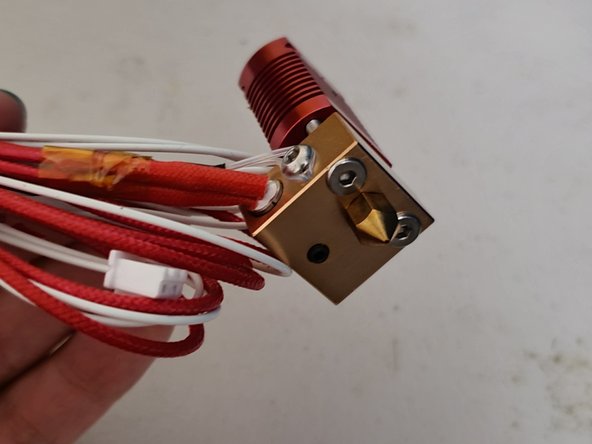 Unthread the attached coupling and pull off the heat sock to reveal the screws holding the assembly together