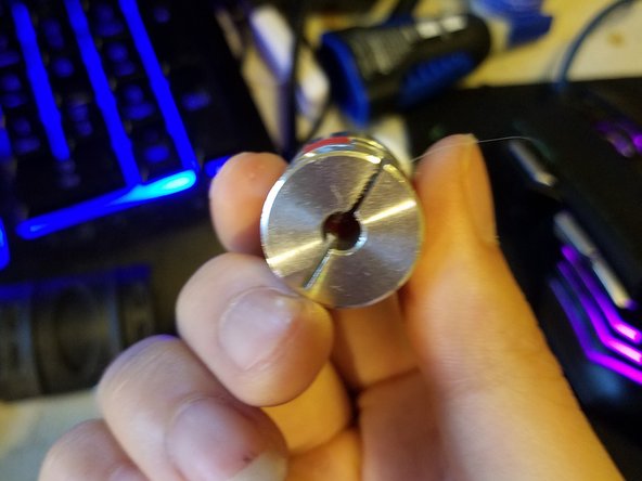 Loosen both screws on it, and slot the smaller end over the motor shaft with the lead screw running into the larger hole.