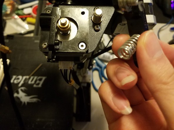 Once the screw is gone, slowly remove the arm up and out, making sure not to let the spring fly off into oblivion